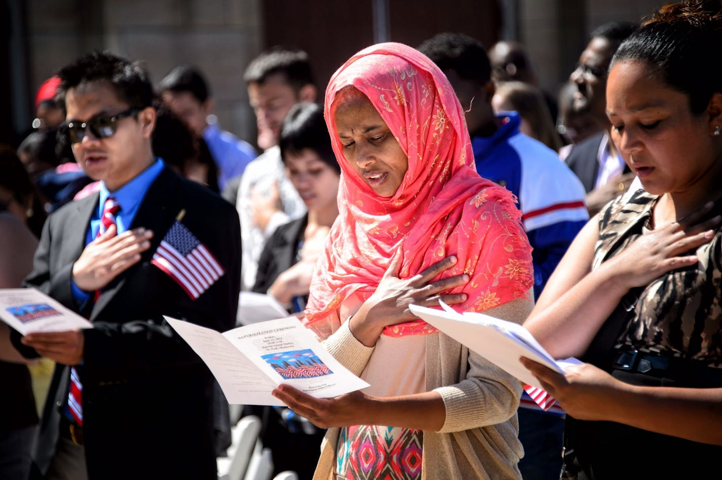 New citizen Zamzam Gulled from Somalia recited the Pledge of Allegiance during the ceremony. 135 immigrants were sworn in as U.S. citizens today, Friday June 13, 2014, at the Harriet Island Pavilion overlooking the banks of the Mississippi River.