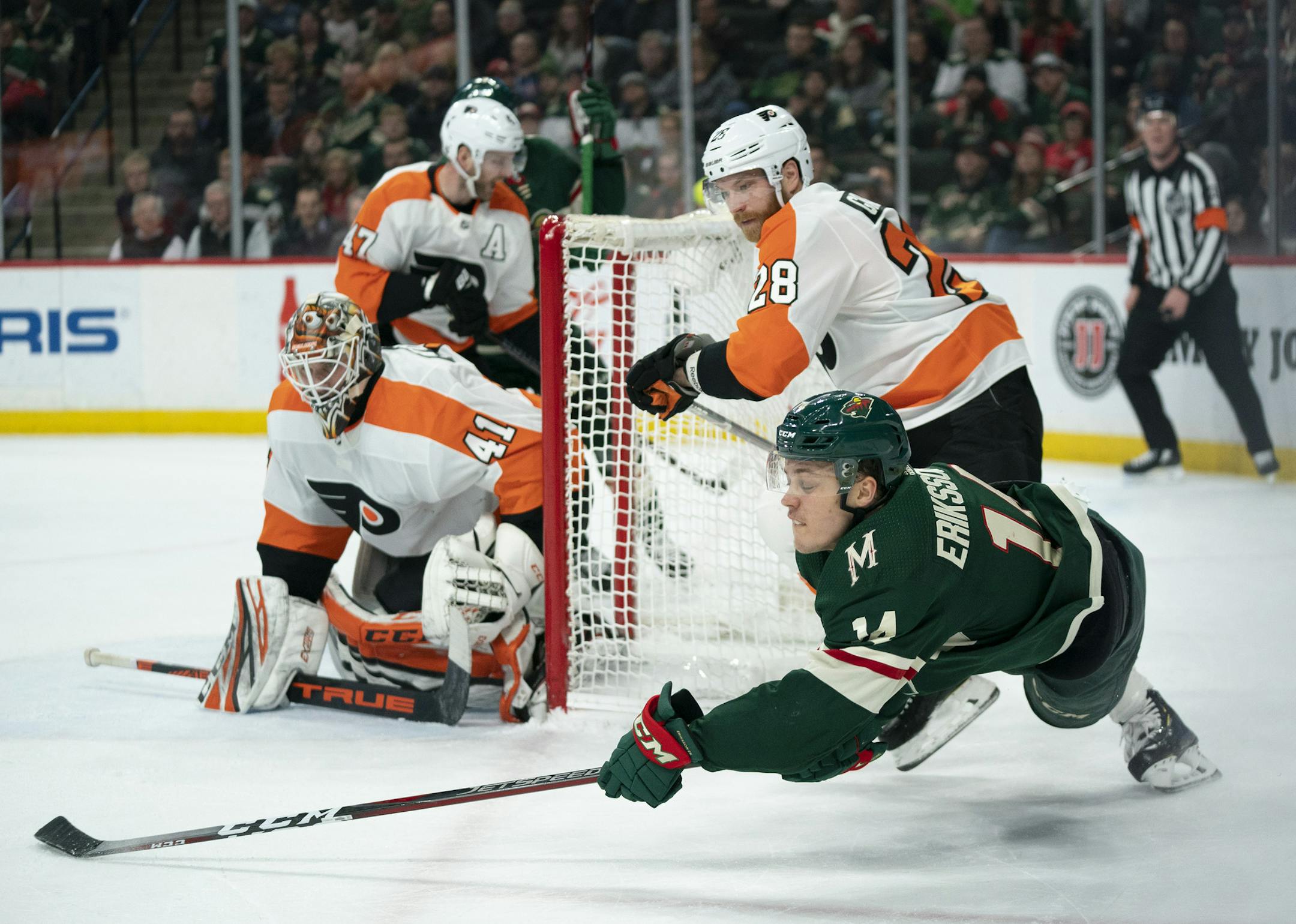 As he fell to the ice, Minnesota Wild center Joel Eriksson Ek (14) managed to feed passed Wild center Luke Kunin for an assist on his second first period goal. ] JEFF WHEELER &#x2022; jeff.wheeler@startribune.com The Minnesota Wild faced the Philadelphia Flyers in an NHL hockey game Tuesday night, February 12, 2019 at Xcel Energy Center in St. Paul.