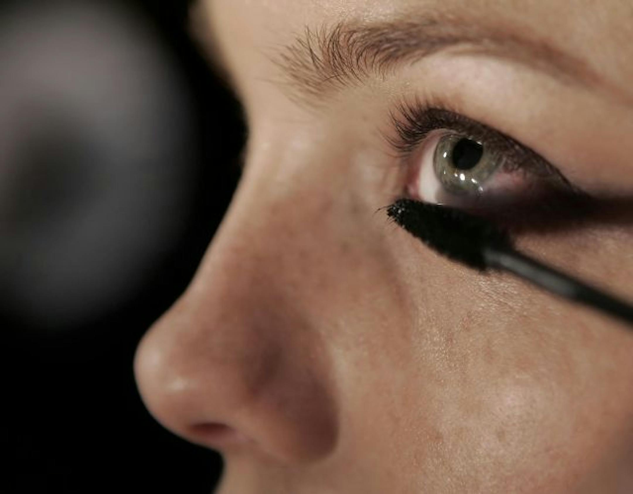 A model gets eye makeup applied before the fall 2006 Vera Wang collection is presented Thursday, Feb. 9, 2006 during fashion week in New York City.