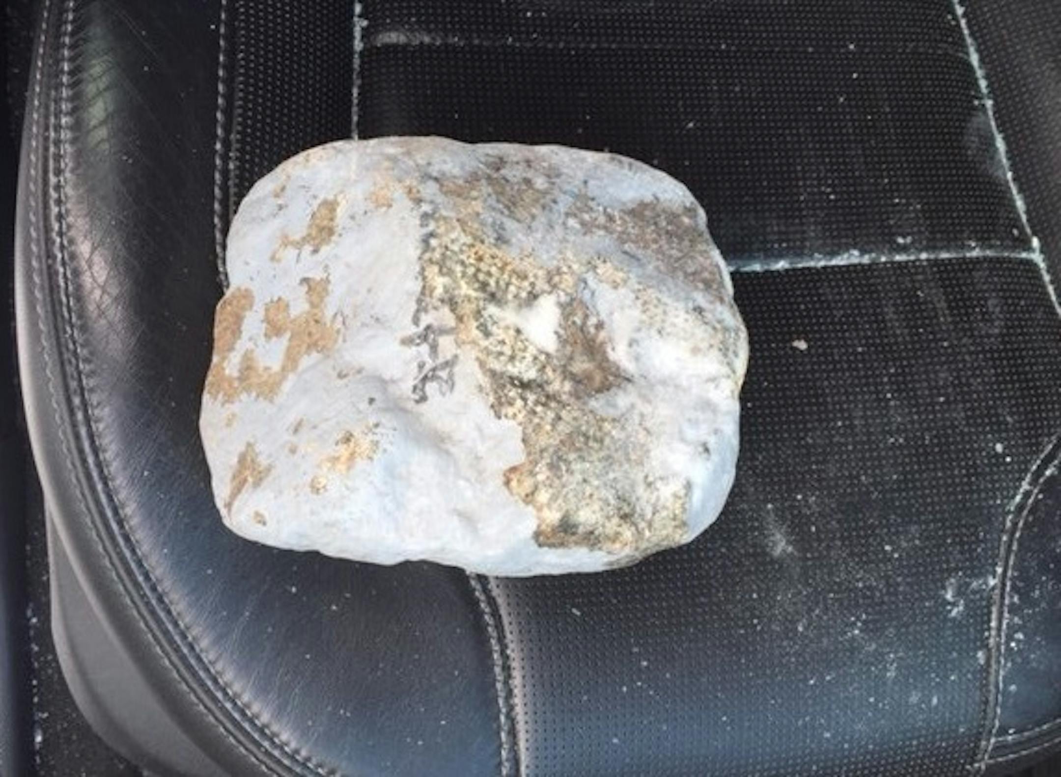 The Minnesota State Patrol is looking for the public's help locating a person who tossed a large rock off an overpass in Duluth on Sunday evening.