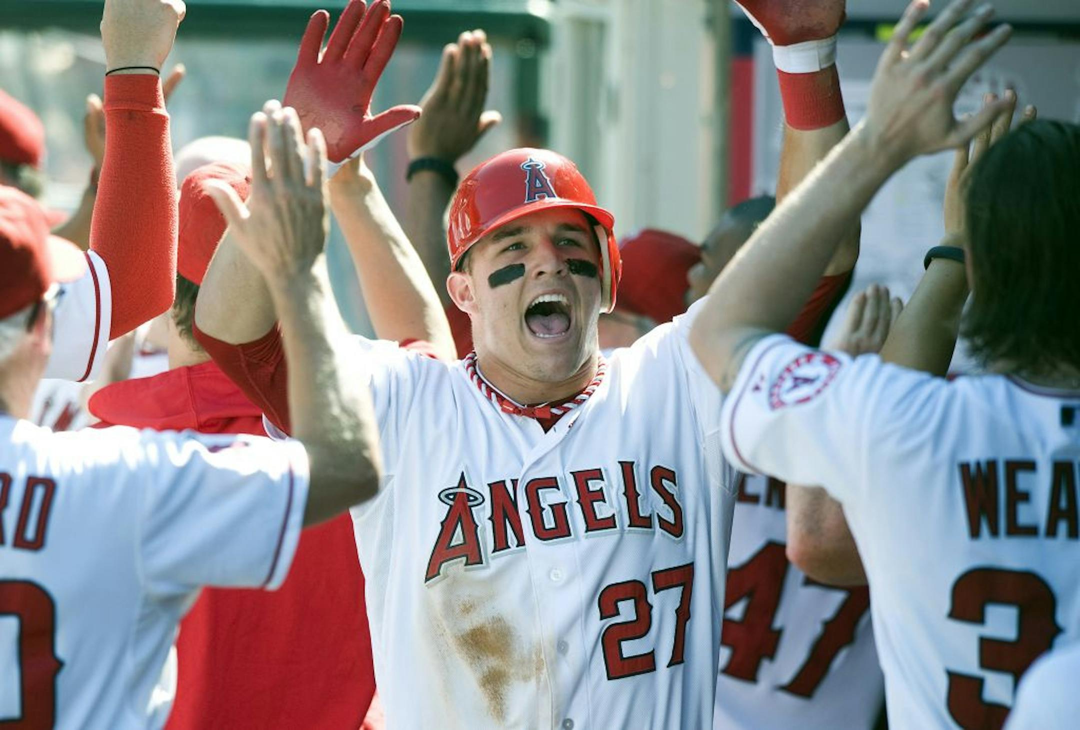 Los Angeles Angels Mike Trout celebrates with his teammates after scoring in the sixth inning against the Chicago White Sox on Sunday, September 23, 2012, in Anaheim, California.
