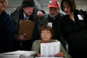 All eyes were focused on a ballot held up by Minneapolis Election Judge Marge Dolan on Wednesday. She was surrounded, from left, by fellow Judge Julia