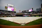 A rain tarp was rolled out over the infield during a rain delay before the start of the Twins game against the Cleveland Indians. ] AARON LAVINSKY �