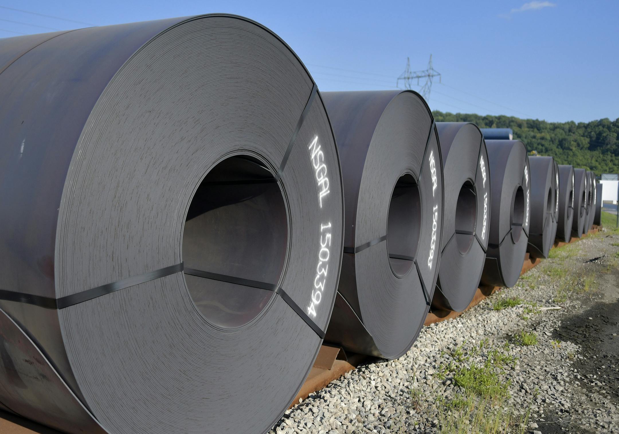 Rolls of steel weighing in at 20 tons or more await shipment at the NUCOR Steel Gallatin plant, Wednesday, July 25, 2018, in Ghent, Ky. The plant has been operating 24 hours a day seven days a week to meet the demand. (AP Photo/Timothy D. Easley)