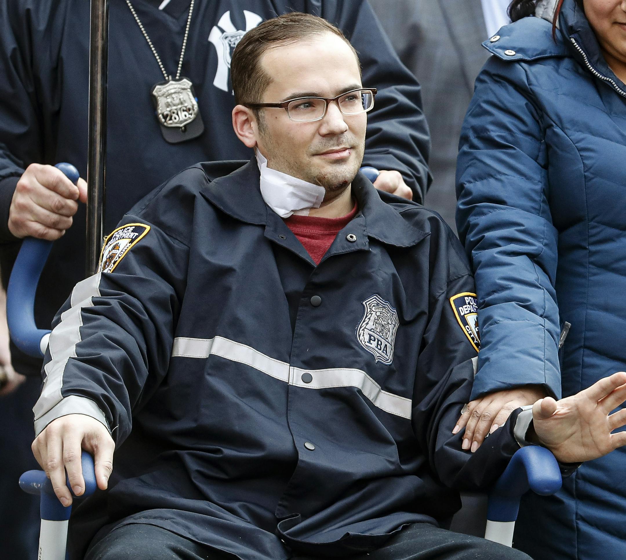 A police officer injured in a shooting the previous evening is released at Lincoln Hospital, Sunday, Feb. 9, 2020, in the Bronx borough of New York. (AP Photo/John Minchillo)