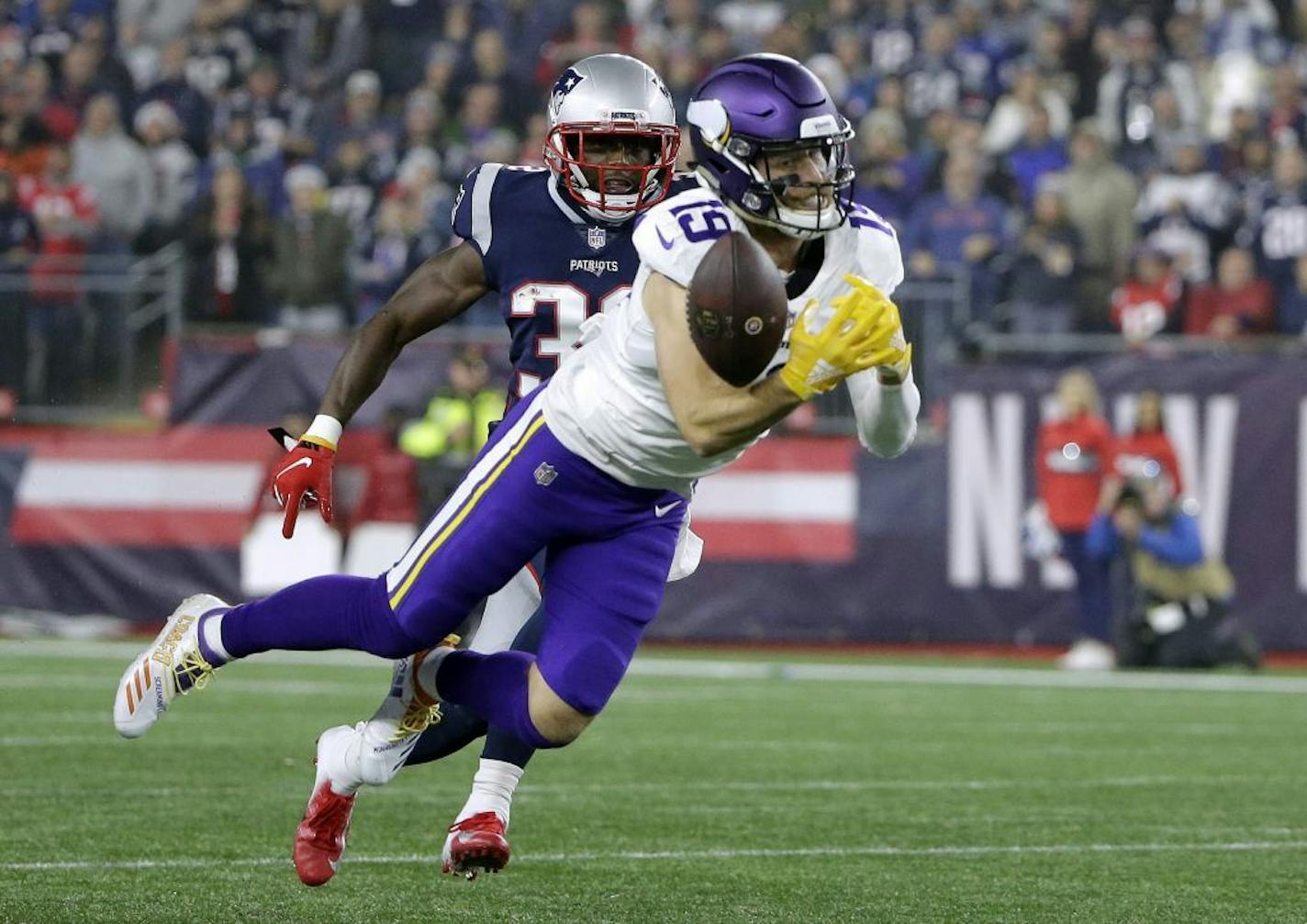 Minnesota Vikings wide receiver Adam Thielen (19) can't catch a pass in front of New England Patriots defensive back Devin McCourty during the second half of an NFL football game, Sunday, Dec. 2, 2018, in Foxborough, Mass.