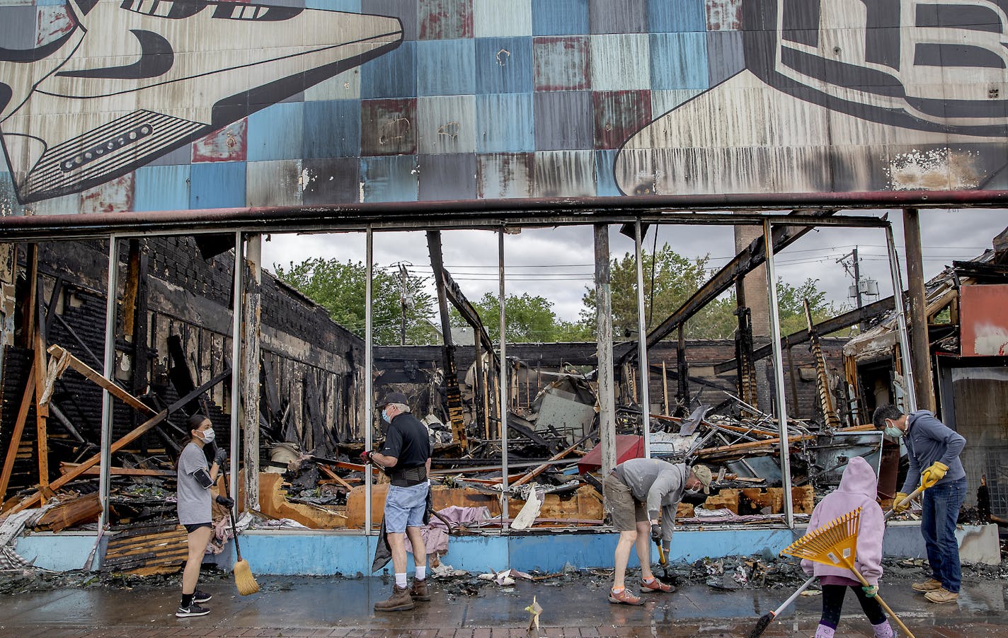 Hundreds of volunteers showed up to clean along University Avenue, organized by Hamline Midway Coalition, Friday, May 29, 2020 in St. Paul, Minn, Minn., following a night of unrest in the death of George Floyd in Minneapolis police custody. (Elizabeth Flores/Star Tribune via AP)