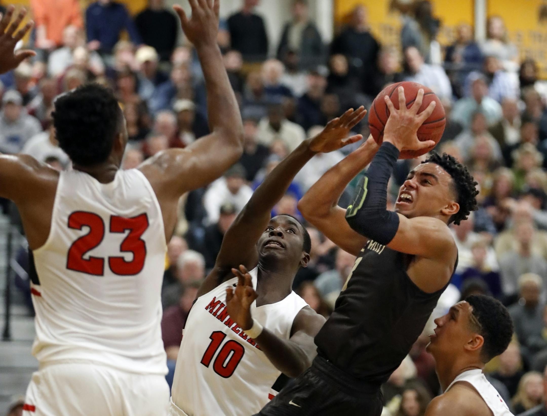 True Jones(3) puts up a shot against JaVonni Bickham(23) of Minnehaha with Prince Aligbe(10) helping and Jalen Suggs(1) trailing.