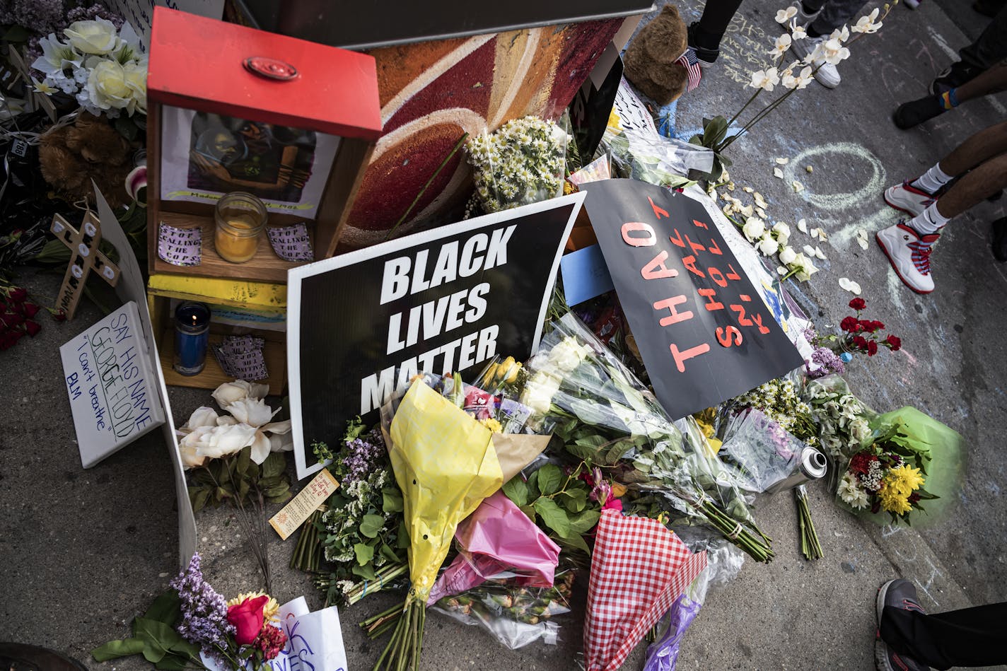 Items are left in honor George Floyd during a protest Tuesday, May 26, 2020, in Minneapolis. Four Minneapolis officers involved in the arrest of Floyd, a black man who died in police custody, were fired Tuesday, hours after a bystander's video showed an officer kneeling on the handcuffed man's neck, even after he pleaded that he could not breathe and stopped moving. (Richard Tsong-Taatarii/Star Tribune via AP)