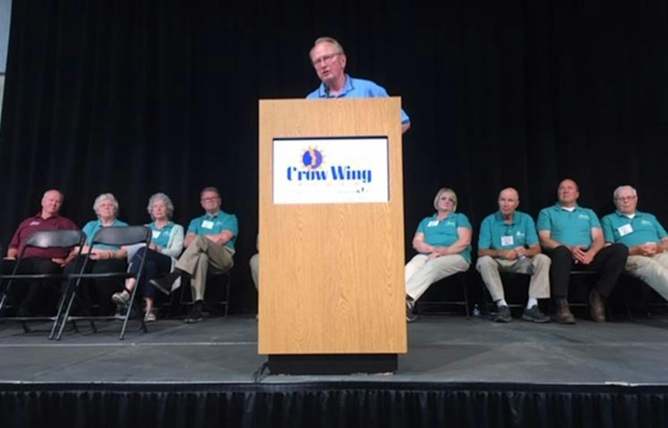 Bruce Kraemer, CEO of Crow Wing Power, defended his $1.9 million bonus before co-op members Saturday, June 9, in Brainerd. At far left is Bryan McColloch, the board member who has led criticism of Kraemer.