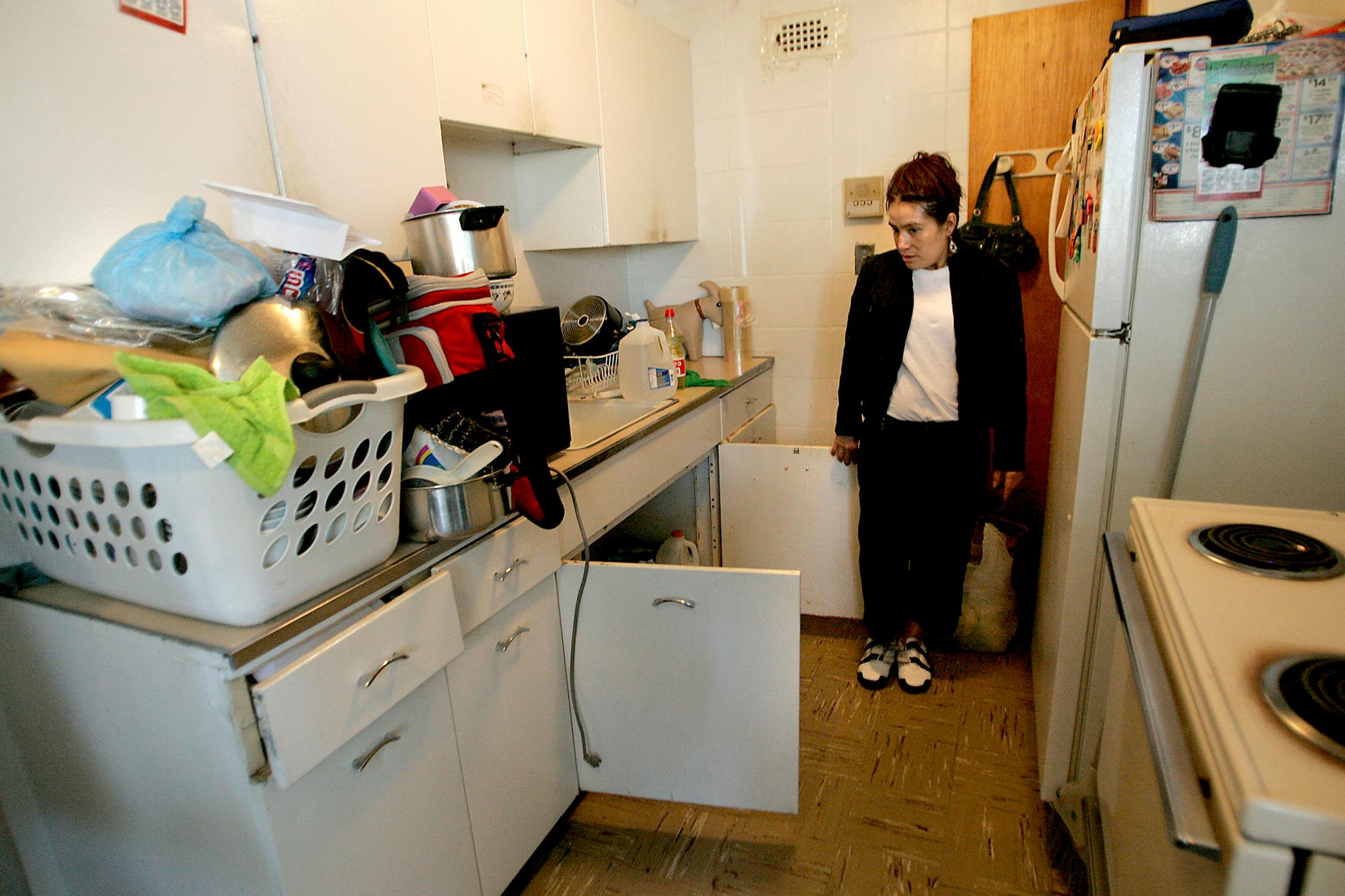 Teresa Alcantor showed the mold that was accumulating underneath the kitchen sink as she prepared to move from the building.