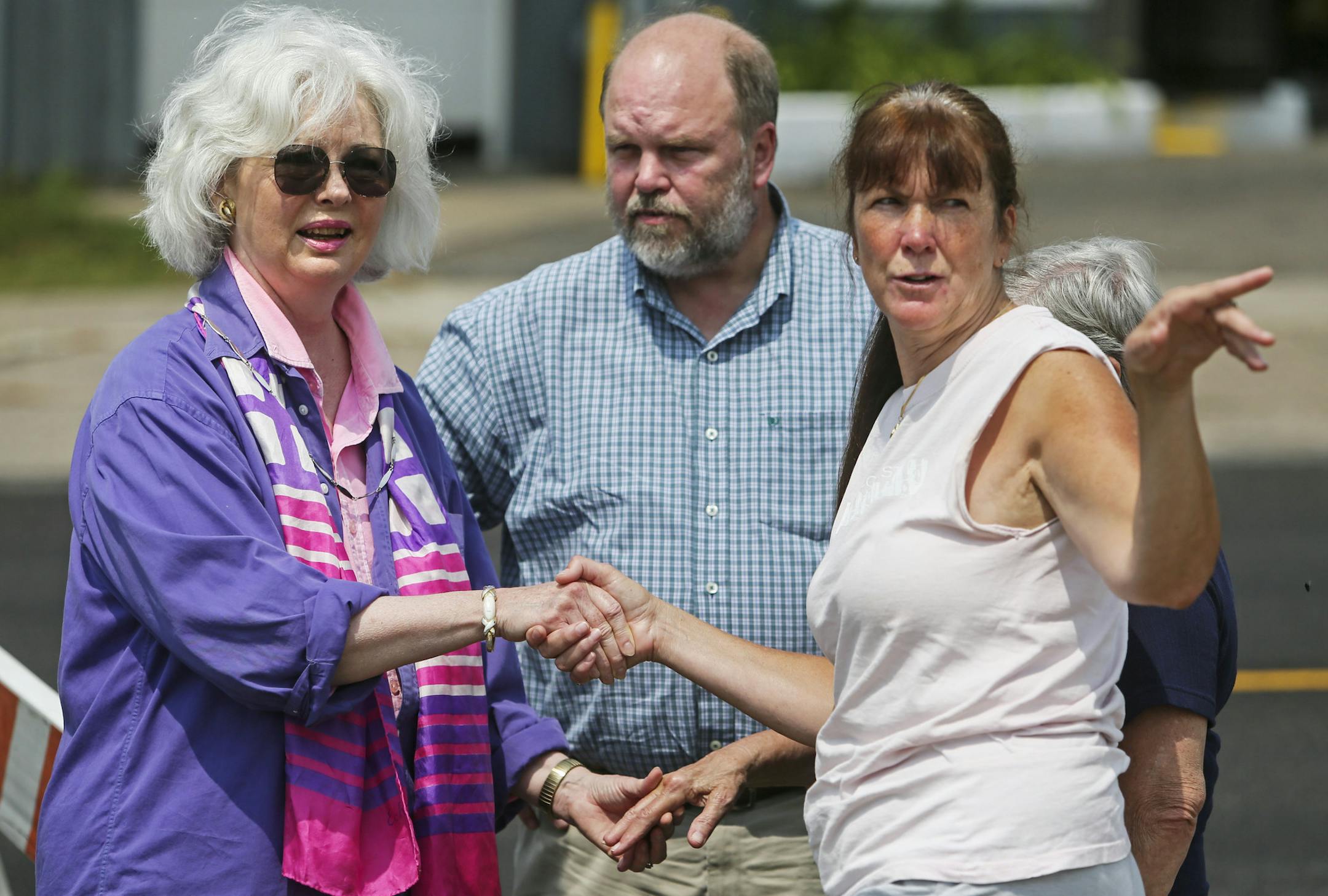 Scott Patrick's brother, Mike Brue, center, arrived at the scene from his home in Alvarado, Minn., with friends Mary Sweeney, left, and Nancy Appenzeller.