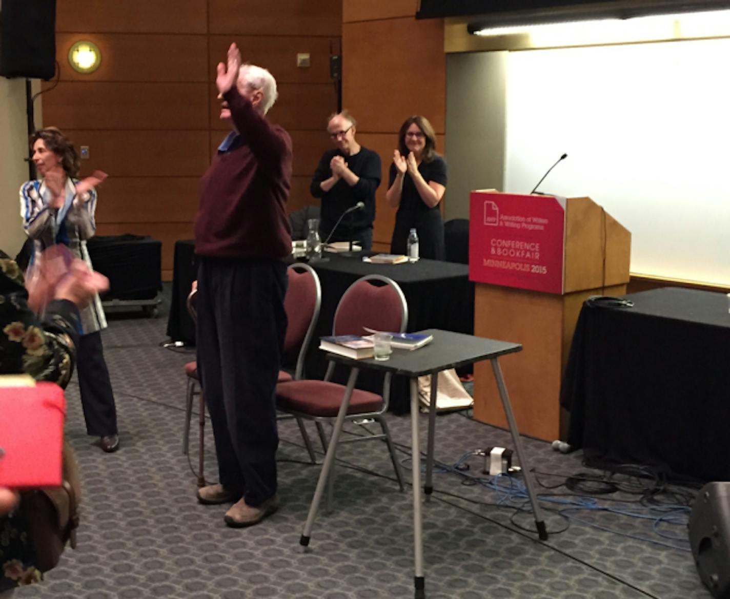 Robert Bly waves to the crowd at AWP after his reading on Saturday.