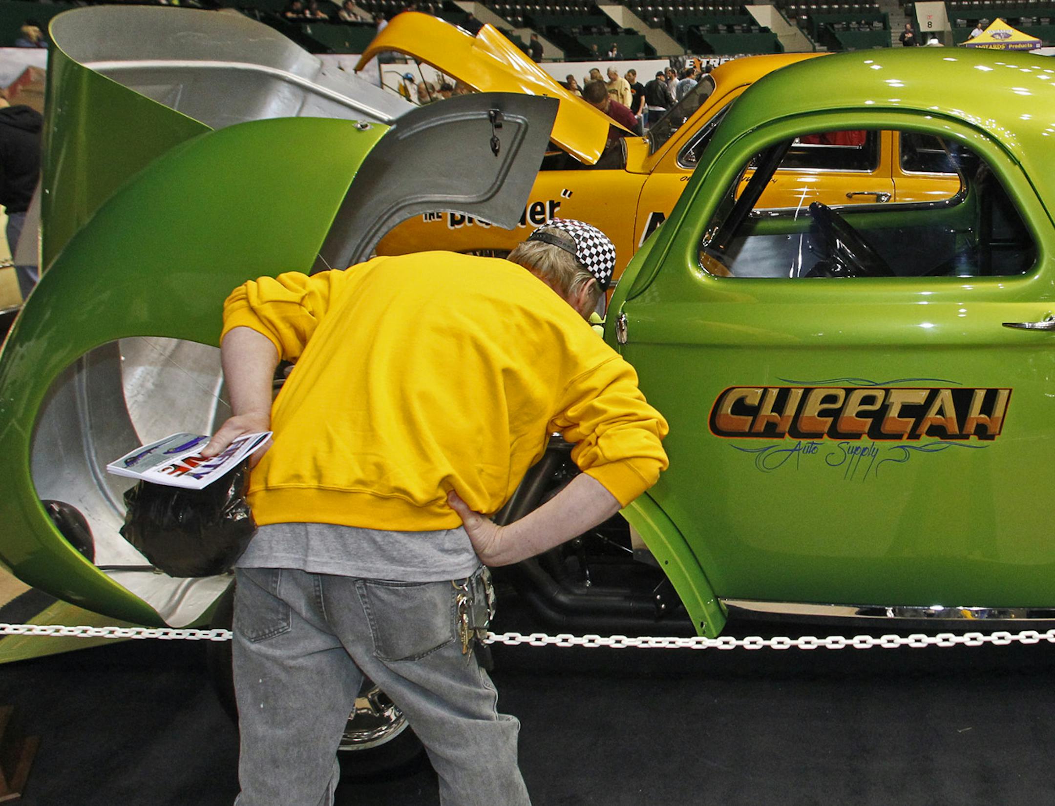 MARLIN LEVISON*mlevison@startribune. GSTA Rod and Custom Spectacular motor vehicle show is taking place this weekend at the State Fairgrounds in St. Paul. More than 100 of the area's top street and hot rods, antiques and custom cars are on display. IN THIS PHOTO: ] A 1940 Willys C.Gas Coupe owned by Alan Tschida of Roseville got a close inspection. ORG XMIT: MIN2013041014001964