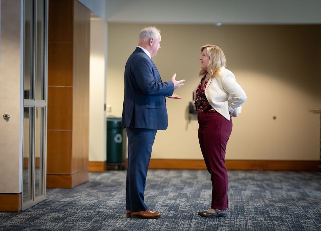 Gov. Tim Walz and House Speaker Melissa Hortman, DFL-Brooklyn Park spoke in a hallway before the release of the February budget forecast Thursday.