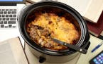The double-decker cheeseburger casserole layers the expected elements (ground beef, tomato, cheese, pickle relish, etc.) in an unexpected slow cooker 