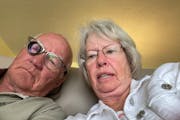 Portrait of Dick and Polly Bramer in which Dick is wearing glasses with a small device on the right lens.