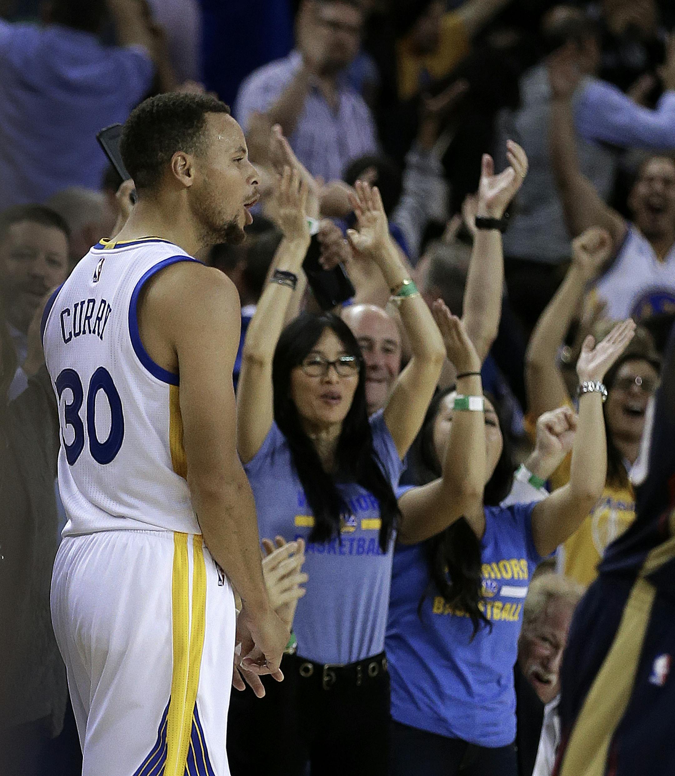 Golden State Warriors' Stephen Curry (30) celebrates a score against the New Orleans Pelicans during the fourth quarter of an NBA basketball game Monday, Nov. 7, 2016, in Oakland, Calif. (AP Photo/Ben Margot)