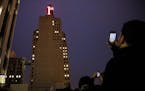 A crowd at the neighboring U.S. Bank building photographed the re-lighting of the iconic red First National Bank Building sign in 2016. The two buildi