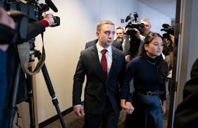 Trooper Ryan Londregan walks hand-in-hand with his wife to his first court appearance in January to answer to murder and manslaughter charges in the k