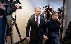 Trooper Ryan Londregan walks hand-in-hand with his wife to his first court appearance in January to answer to murder and manslaughter charges in the k