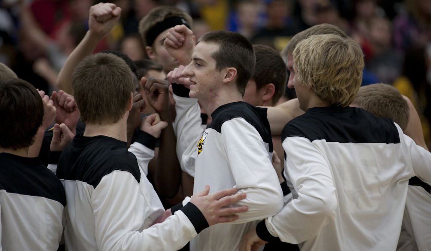 Zach Gabbard, center, huddled with Perham teammates before a game Thursday. He later scored on his only shot, his first points since his heart attack last year.