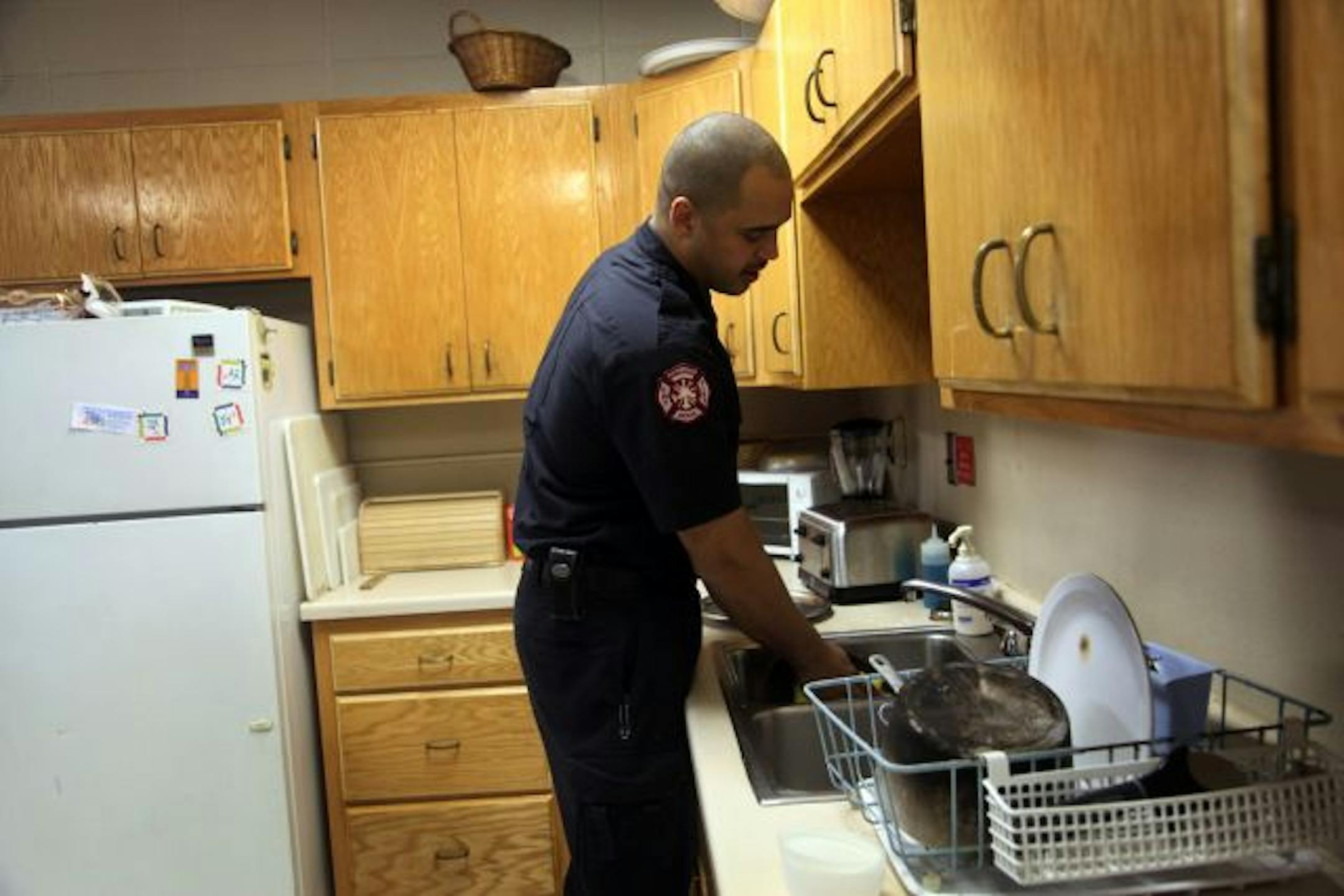 When he's not responding to fires or medical emergencies, McClellan takes a turn rescuing the fire station's kitchen from dirty dishes. Firefighters cook as a group, sharing the cost.