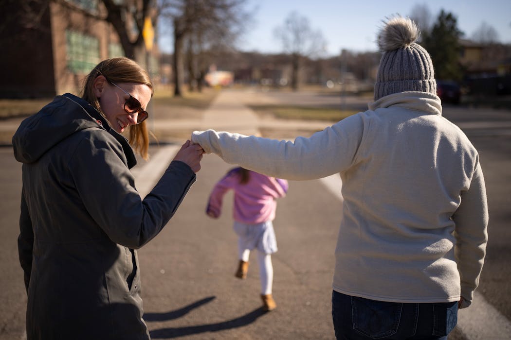 Julianna, left, and Catherine Sheridan walk with their two kids to a playground in their St. Paul neighborhood. They are a married, same-sex couple fighting to keep sole custody of their 5-year-old daughter, who was conceived through artificial insemination using the sperm of a close friend.