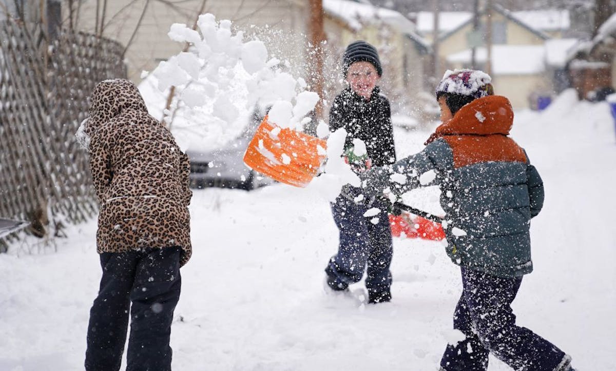 Alma Connoy, 7, braced for a shovel full of snow from friend Sean Barker, 7, Tuesday in St. Paul as they enjoyed a good-natured snowball fight with Al