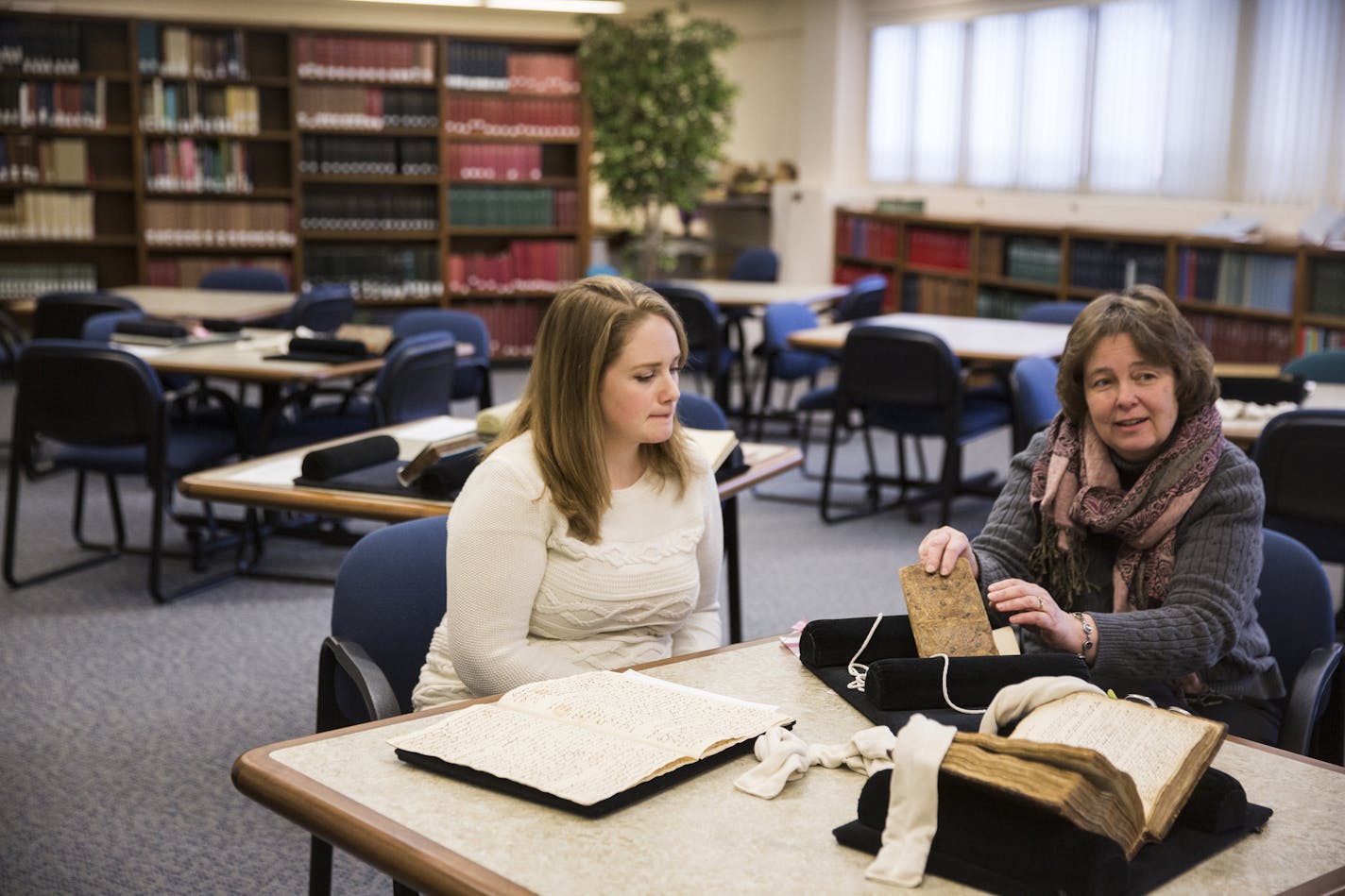 Emily Beck, left, exhibit coordinator and project manager, and Lois Hendrickson, interim curator, speak about the collection of rare recipe books and journals at the Wangensteen Historical Library of Biology and Medicine on the campus of the University of Minnesota.