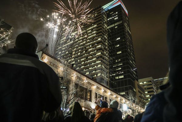 Fireworks light the cold night sky over downtown Minneapolis as part of the new Minneapolis Holiday Market.