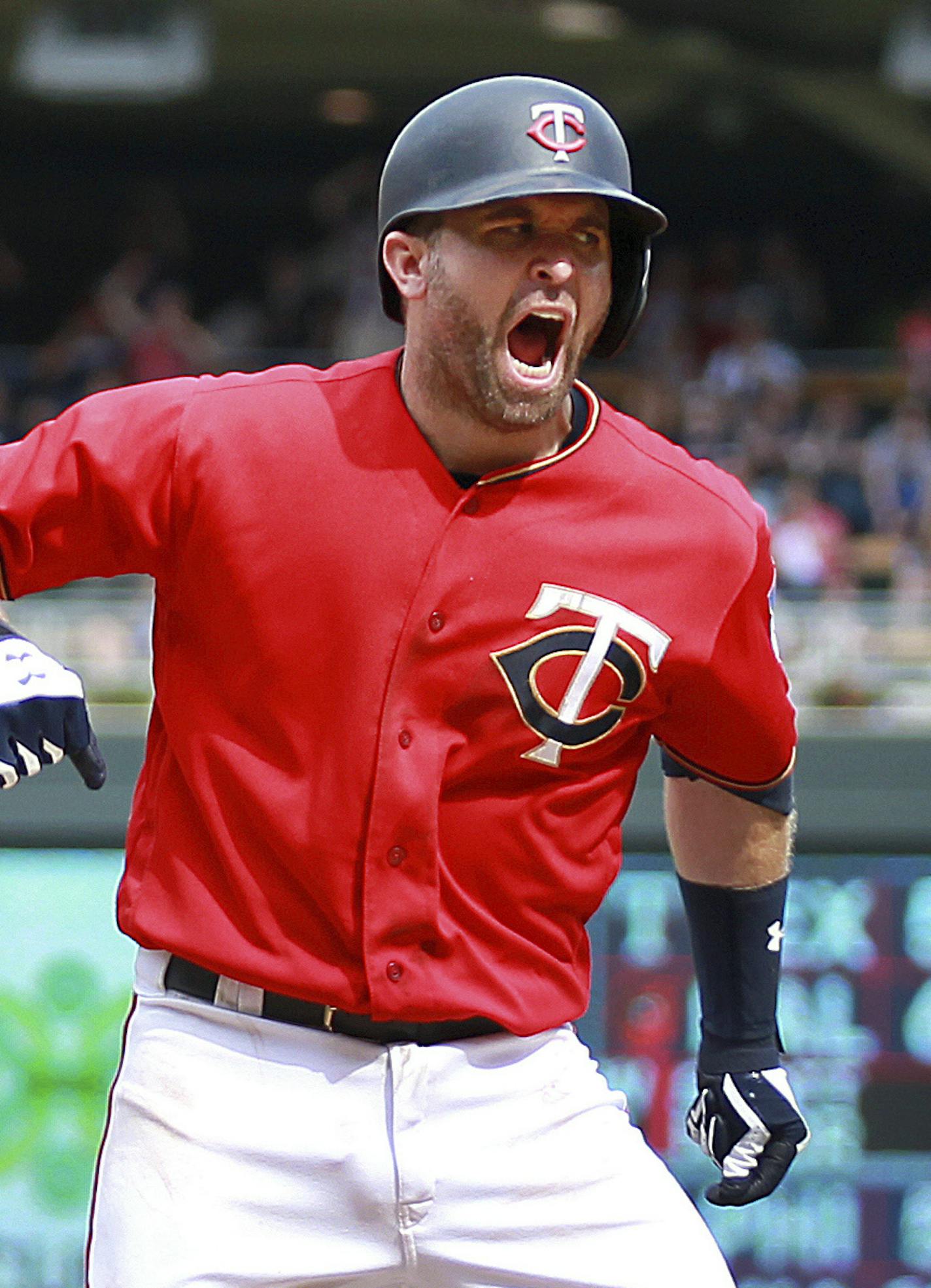 Minnesota Twins' Brian Dozier celebrates while scoring on a balk by Tampa Bay Rays pitcher Diego Castillo in the seventh inning during a baseball game Sunday, July 15, 2018, in Minneapolis. (AP Photo/Andy Clayton-King)