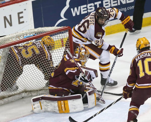 Adam Krause scored a goal on Gophers goalie Adam Wilcox during the first period.