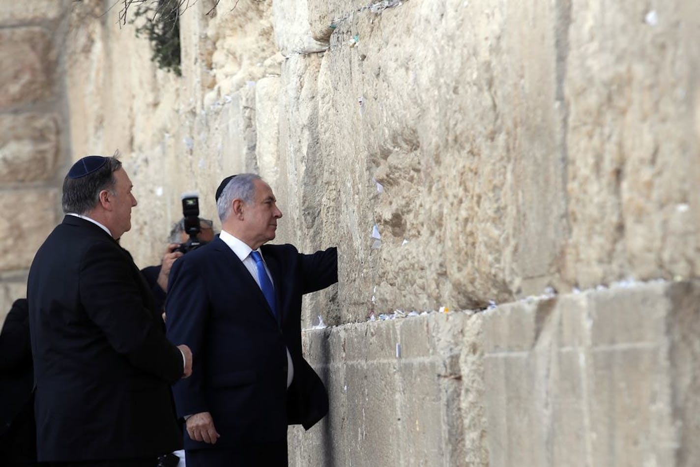 Israeli Prime Minister Benjamin Netanyahu accompanied by U.S. Secretary of State Mike Pompeo touches the stones of the Western Wall during his visit to the site in Jerusalem's Old City, Thursday, March 21, 2019.