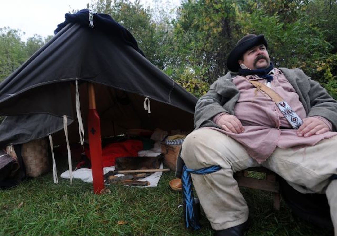 In this Friday, Oct. 2, 2009 photo, Derek Berg sits on a chair outside of his small diamond tent at the Big Island Rendezvous & Festival at the Big Island Rendezvous & Festival in Albert Lea, Minn.