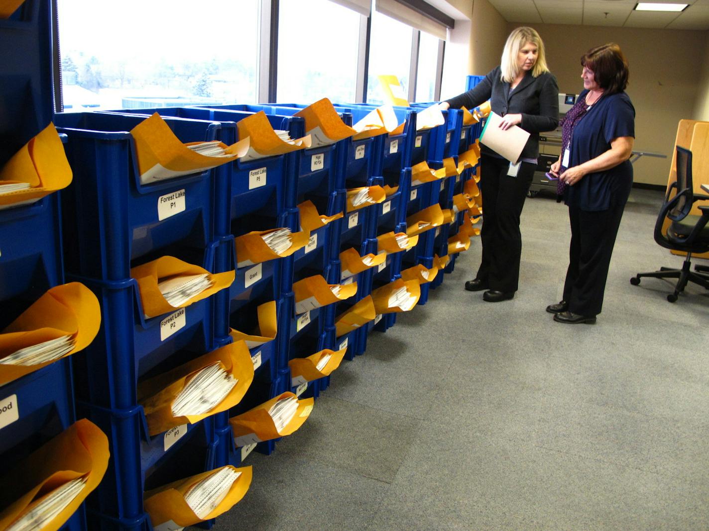 Absentee ballots were sorted by precinct at the Washington County Government Center. Jennifer Wagenius, left, who oversees the elections division and elections supervisor Carol Peterson reviewed counting procedures on Election Day.