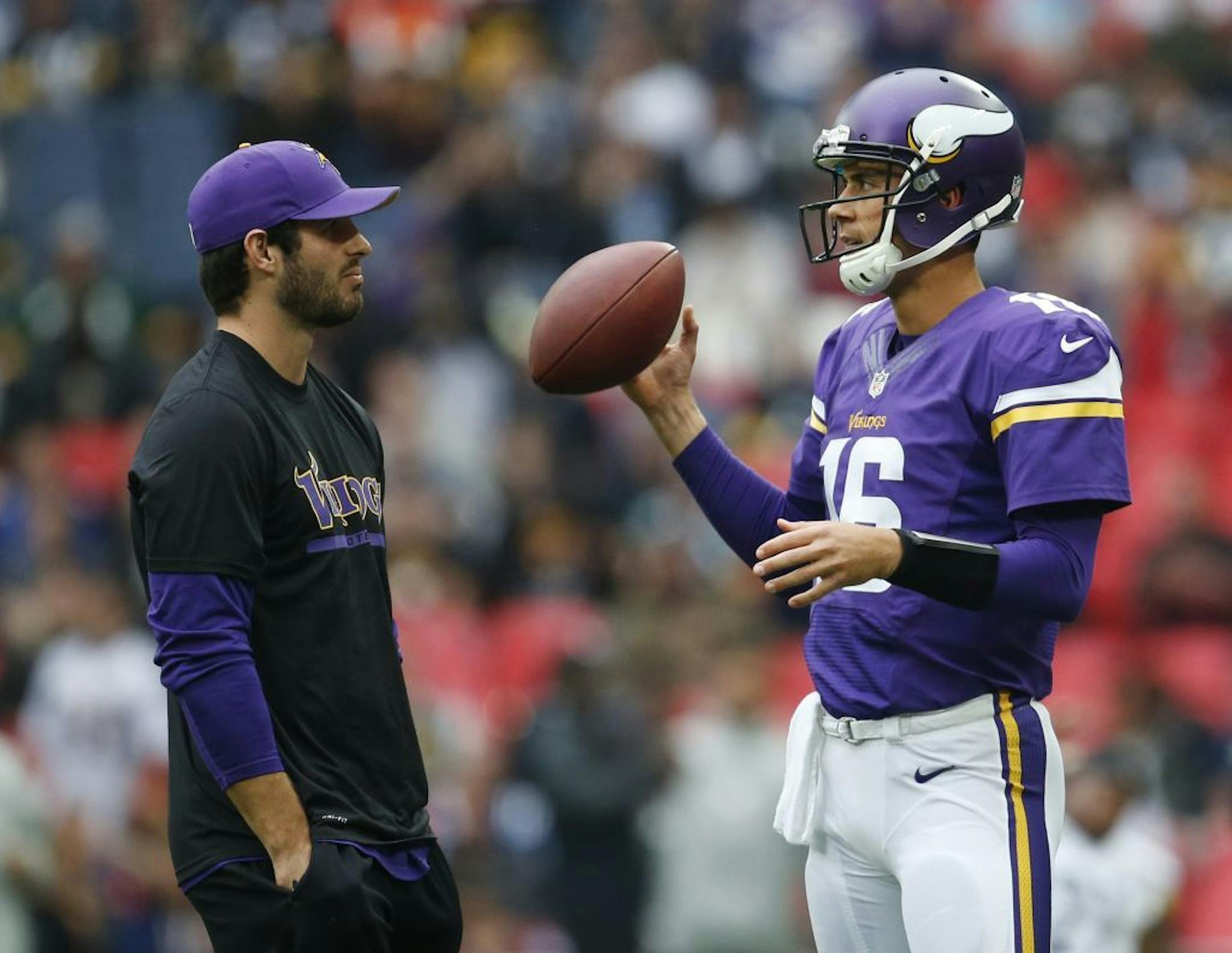 Injured Minnesota Vikings quarterback Christian Ponder, left, chats with quarterback Matt Cassel during warms up before their NFL football game against the Pittsburgh Steelers at Wembley Stadium, London, Sunday, Sept. 29, 2013.