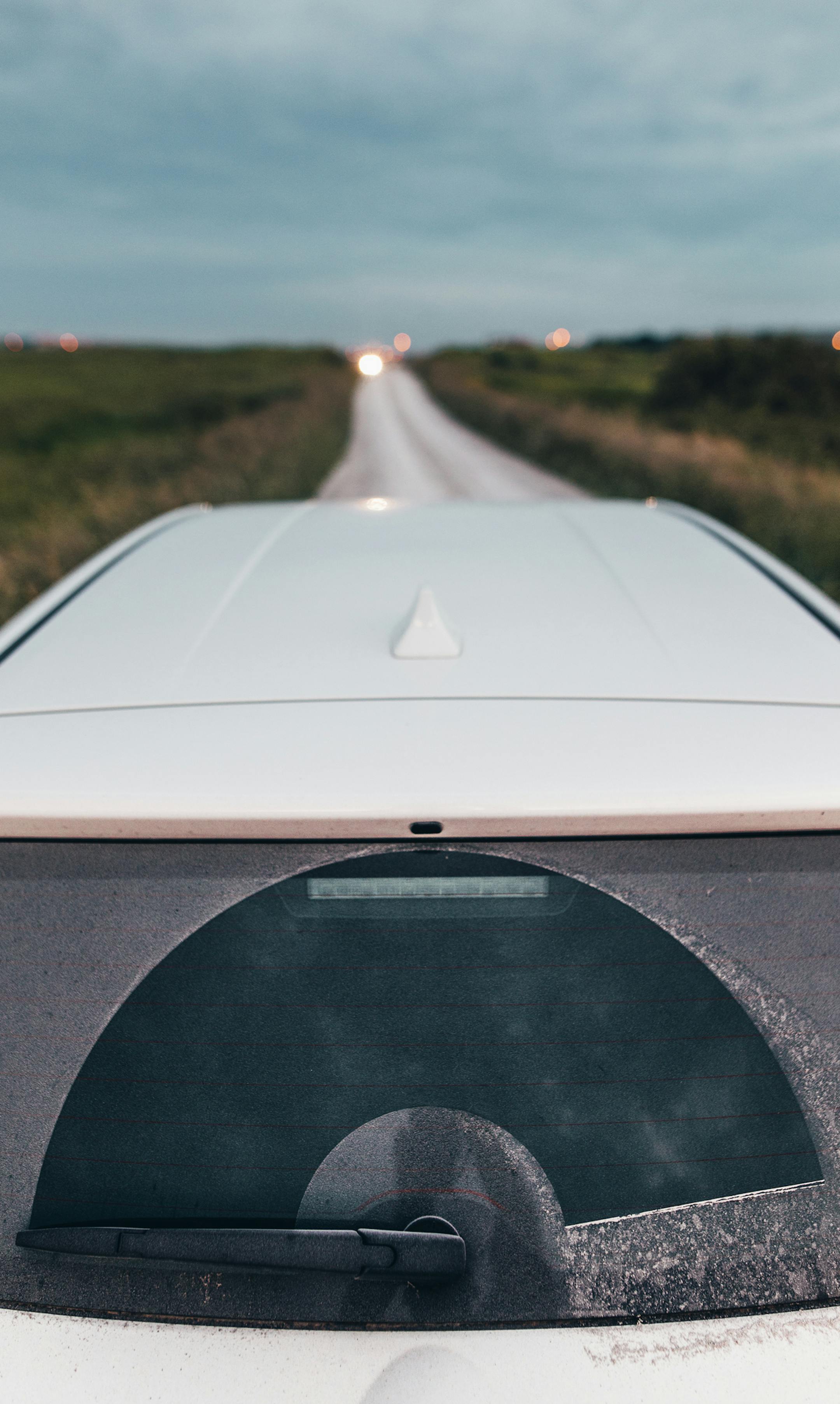 A dirty car at an unpaved road