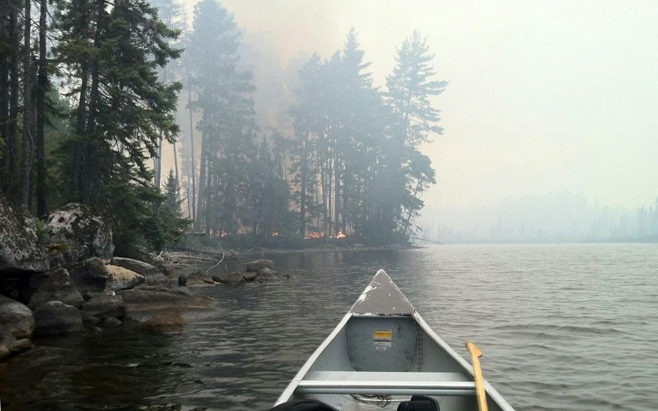 Firefighters working the Cummings Lake fire were flown into the area on Forest Service float planes with canoes loaded onto the floats. The crews then paddled to the lakeshore.