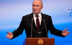 Russian President Vladimir Putin gestures while speaking on a visit to his campaign headquarters after a presidential election in Moscow, Russia, earl
