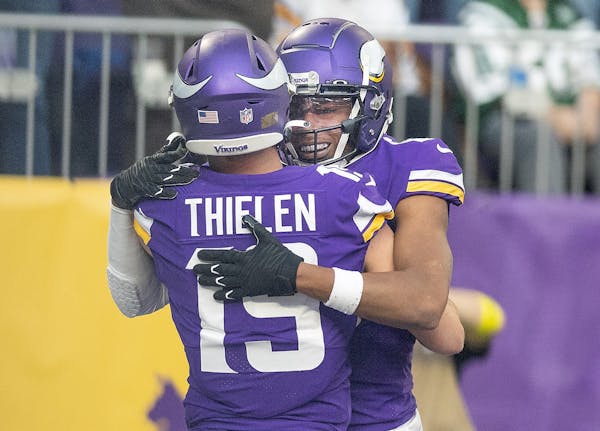 Minnesota Vikings wide receiver Adam Thielen (19) celebrates with Minnesota Vikings wide receiver Justin Jefferson (18) after he made a touchdown in t