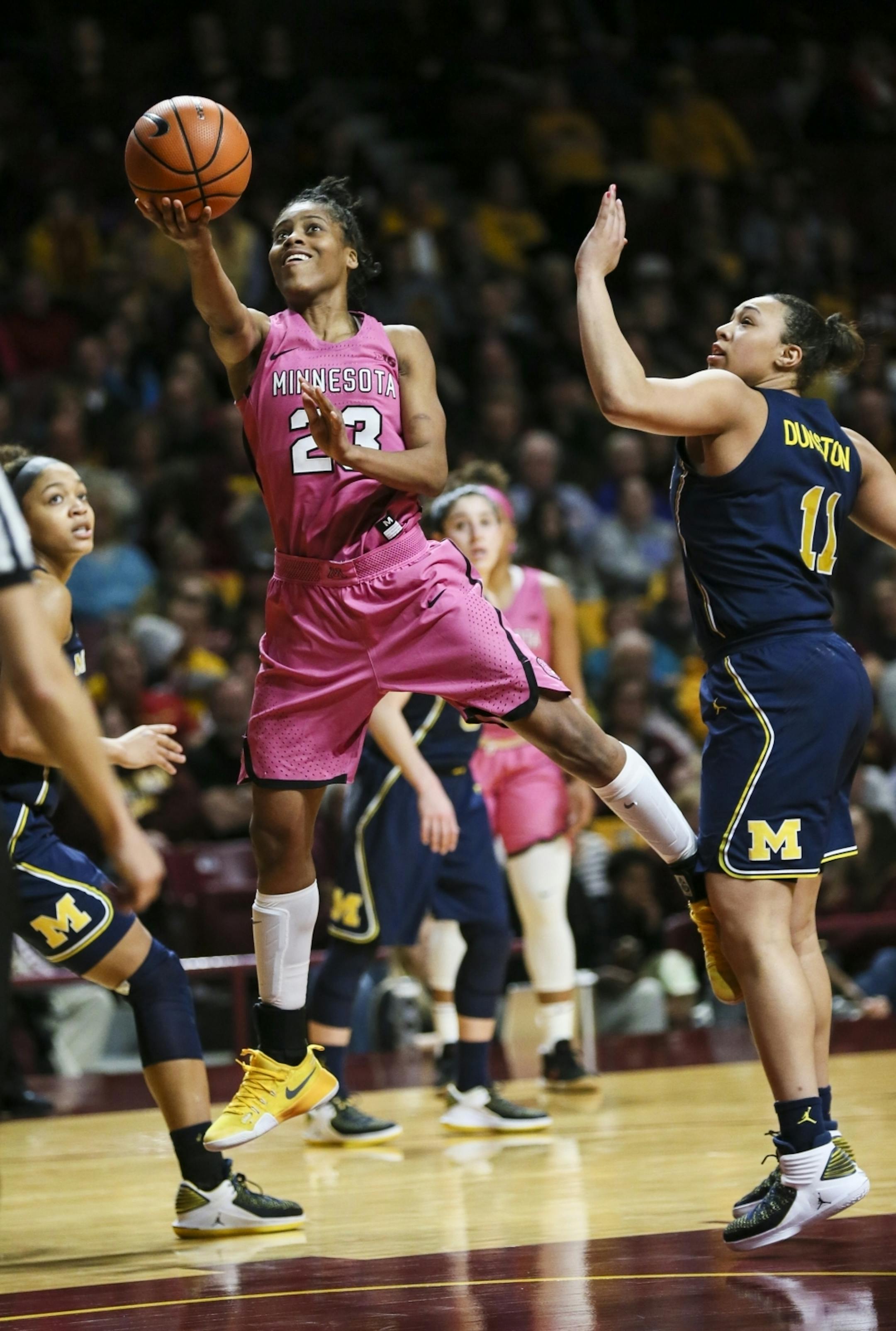 Minnesota Golden Gophers guard Kenisha Bell (23) wound up for a shot in the first half
