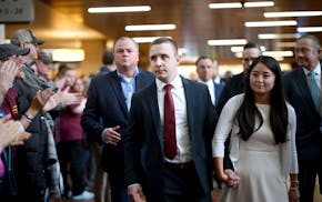 Ryan Londregan, a Minnesota State Trooper, center, arrives before a court appearance at Hennepin County Government Center on Monday. Londregan is char