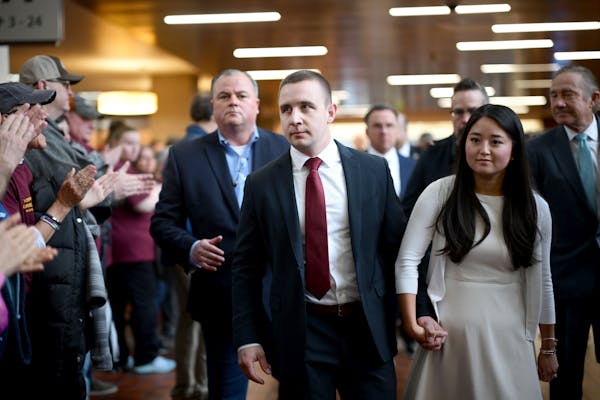 Ryan Londregan, a Minnesota state trooper, center, arrives before a court appearance at Hennepin County Government Center on Monday. Londregan is char