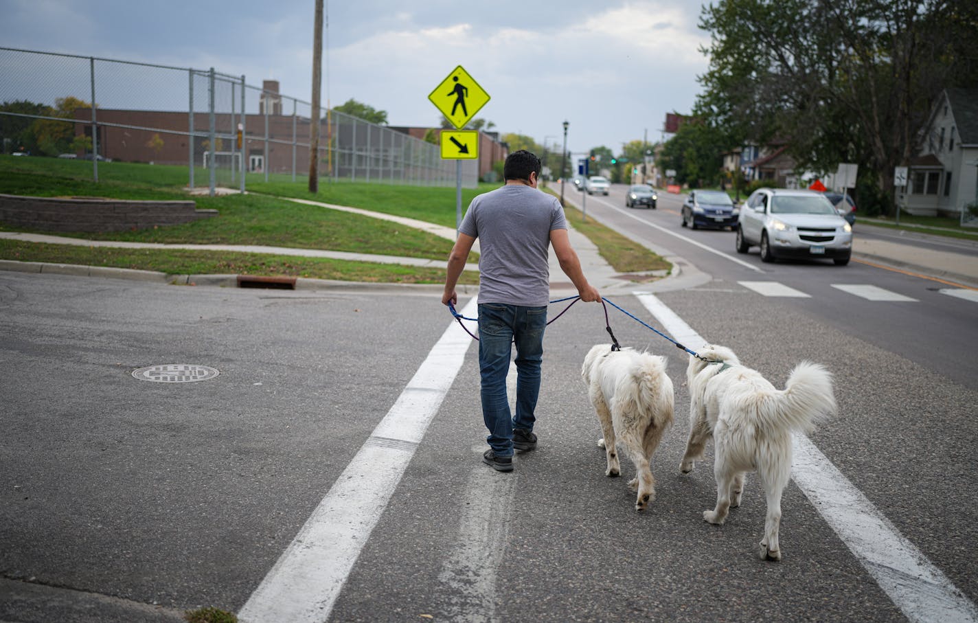 Ismael took his two dogs for a walk to a nearby neighborhood park Tuesday, Oct. 3, 2023 St. Paul, Minn. Ismael, who entered the U.S. from Mexico without legal permission in 1998. The government dropped deportation proceedings against him due to prosecutorial discretion, but due to a quirk in the law it won't let him have a work permit. ] GLEN STUBBE • glen.stubbe@startribune.com