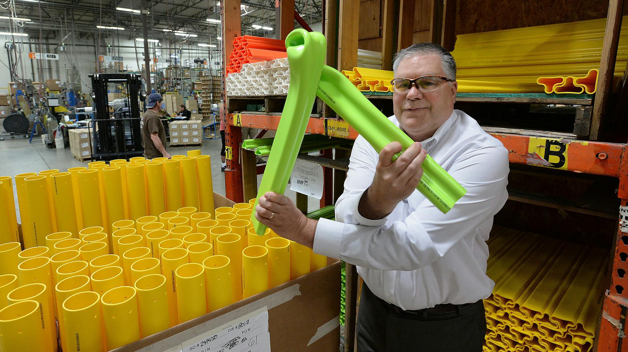 Peter Speer, vice president of sales at Pexco, demonstrates the flexibility and durability of the company's traffic safety poles at the company's manufacturing center in Fife on Wednesday, June 11, 2014. The small company ships product in a variety of styles and colors all over the world. Federal insurance from the little known Export-Import Bank covers $2 million of Pexco's sales. (Drew Perine/Tacoma News Tribune/MCT) ORG XMIT: 1154007