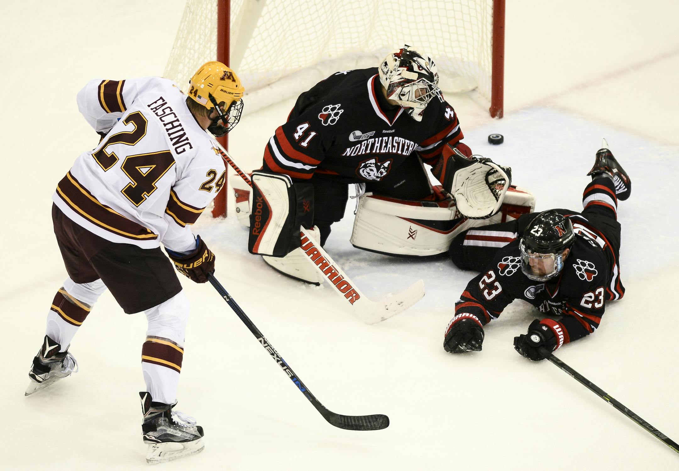 University of Minnesota forward Hudson Fasching (24) scored hist second goal of the night on Northeastern goalie Ryan Ruck (41) as defenseman Colton Saucerman (23) fell to the ice during a power play late in the first period Saturday. ] (AARON LAVINSKY/STAR TRIBUNE) aaron.lavinsky@startribune.com The University of Minnesota Gophers men's hockey team played the Northeastern Huskies on Saturday, Oct. 24, 2015 at Mariucci Arena in Minneapolis, Minn.