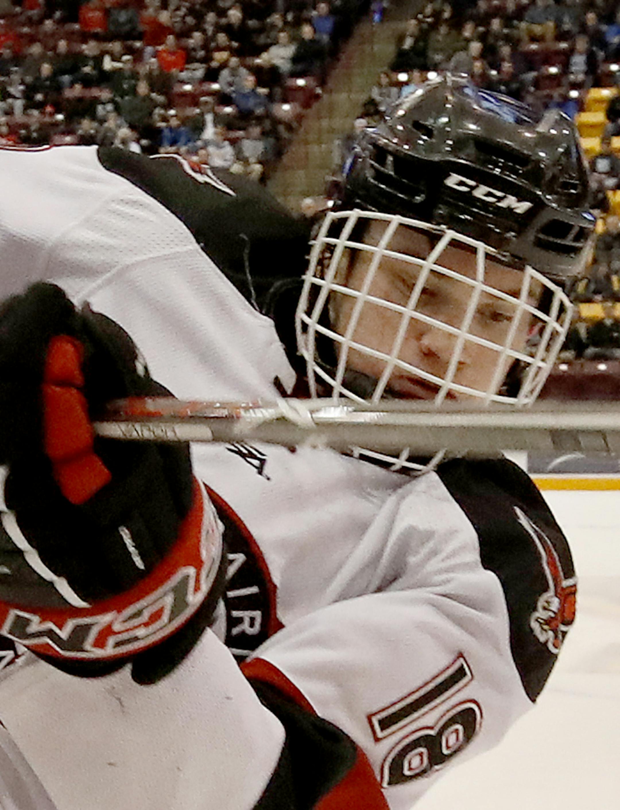Mack Byers (12) of Holy Family and Jack Jensen (18) of Eden Prairie fought for position in the first period. ] CARLOS GONZALEZ ï cgonzalez@startribune.com - March 1, 2017, Minneapolis, MN, Mariucci Arena, High School / Prep Boys Hockey Section 2 Finals; Eden Prairie vs. Holy Family ORG XMIT: MIN1703012045116797