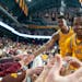 The Gophers' Elijah Hawkins, front, and Pharrel Payne high-five fans Saturday at Williams Arena. Minnesota beat Penn State 75-70.