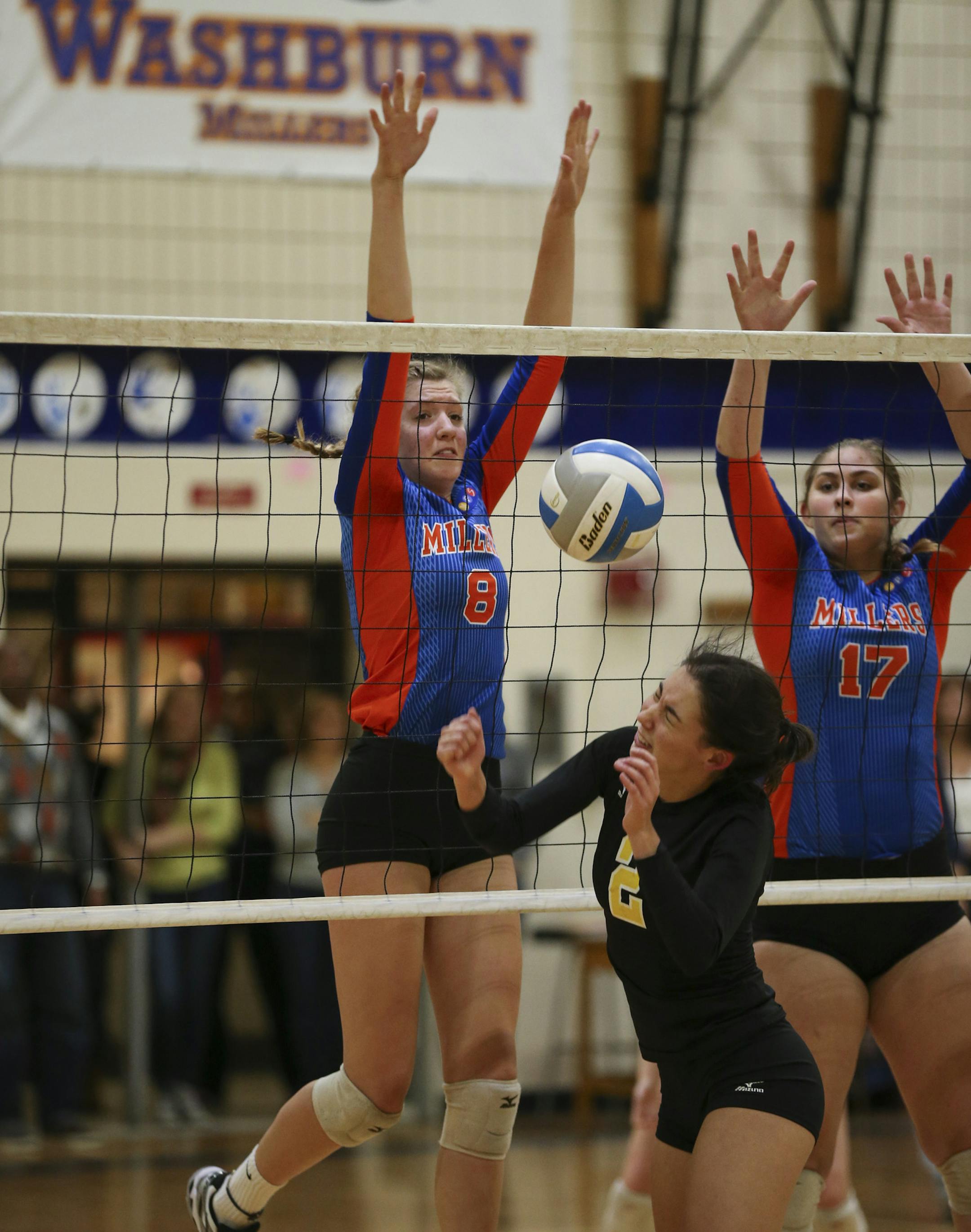 Washburn seniors Rachel Stark (8) and Sonje Odegard (17) teamed up to block a shot by Como Park's Olivia Berven during the first game at Washburn Monday night. ] JEFF WHEELER • jeff.wheeler@startribune.com The Washburn Millers volleyball team defeated Como Park to claim the Twin City Championship Monday night, October 26, 2015 at Washburn High School in Minneapolis.